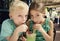 Cute kids sharing a mint julep drink at a cafe