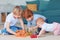 Cute kids, siblings playing toys together on the carpet at home