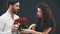 Cute kinky woman gives man ring and roses and forces him to make her proposal. He doesn`t want to do it.