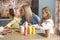 Cute kissing mom with daughters during preparing Easter decorations