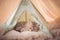 cute kitty sleeping in little tent in pastel colors