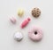 Cute knit toys for children. Cookies, macarons, candy and donut imitations on wooden background top view