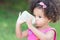 Cute latin girl drinking from a baby bottle