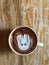 Cute Latte art coffee on the wooden table, latte art coffee shape look like `Groot`