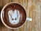 Cute Latte art coffee on the wooden table, latte art coffee shape look like `Groot`