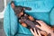 Cute lazy dachshund puppy poses with belly up in pet bed while human makes him relaxing massage, top view. Wellness and