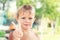 Cute liitle caucasian blond boy smiling and showing peace sign with fingers. Child making victory gesture by arm. Happy childhood