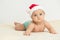 Cute little 5 months old baby boy wearing Santa Claus hat