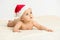 Cute little 5 months old baby boy wearing Santa Claus hat