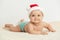 Cute little 5 months old baby boy wearing Santa Claus hat