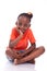 Cute little african american girl sitting on the floor - Black c