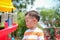 Cute little Asian 2 - 3 years old toddler boy child sweating during having fun playing, exercising outdoor at playground, Heat