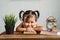 Cute little asian baby toddler making funny face or smiling while reading books with alarm clock