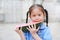 Cute little Asian child girl in school uniform enjoy eating fresh sliced watermelon