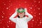 Cute little asian girl reindeer with floating snow on red christmas background
