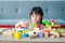 Cute little asian girl Smiling happy playing with wooden toys.