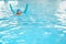 Cute little Asian toddler boy child kicking feet in swimming costume wear swimming goggles use pool noodle and kickboard learn to