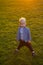 Cute little baby in autumn park with yellow leaves. The boy sits in the autumn leaves in the park. Little boy. Golden