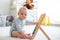 Cute little baby boy, playing with abacus at home