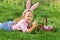 A cute little baby girl collects Easter eggs in the garden