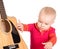 Cute little baby musician playing guitar isolated on white background.