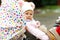 Cute little beautiful baby girl sitting in the pram or stroller on cold day