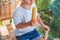 Cute little blond boy eating a homemade icecream sitting on a wooden chair.