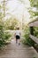 Cute Little Blond Boy Kid Walking on Tiny Wooden Bridge Outside at the Park while Exploring on an Adventure in New York Summer