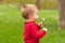 Cute little boy blowing on dandelion