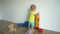 Cute little boy building structure out of blocks at home. Gimbal motion