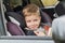 Cute little boy in car sitting in car seat