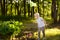 Cute little boy catches butterflies with scoop-net on sunny meadow.Study of nature. Young naturalist