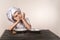 A cute little boy in a chef`s costume cooks food with emotions thinks