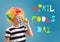 Cute little boy with clown makeup and party whistle on color background. April fools\' day celebration