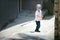 Cute little boy crossing narrow street