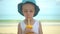 Cute little boy drinking fresh tropical mango smoothie shake in beach. Summertime concept.