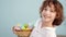 Cute little boy with an Easter basket smiling looking at the camera