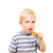 Cute little boy eating delicious cookie isolated