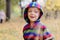 Cute little boy enjoying autumnal nature. Portrait of boy in Autumn Woods.