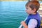 Cute little boy enjoying ride on a small boat.