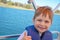 Cute little boy enjoying ride on a small boat.