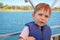 Cute little boy enjoying ride on a small boat.