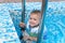 Cute little boy enjoying a swim in a pool