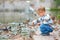 Cute little boy feeding ducks