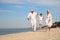 Cute little boy with grandparents spending time on sea beach