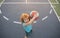 Cute little boy holding a basket ball trying make a score. Sport for kids, Top view.