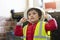 Cute little boy holding helmet and reflective vest, Child pretending a worker constrution wearing safety jacket and helmets