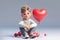 a cute little boy hugging a big red heart, ai generated