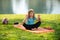 Cute little boy, kid meditating in park. Portrait of child doing yoga. Calmness and relax, meditates while practicing