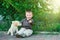 Cute little boy kneeling with his puppy labrador smiling at camera